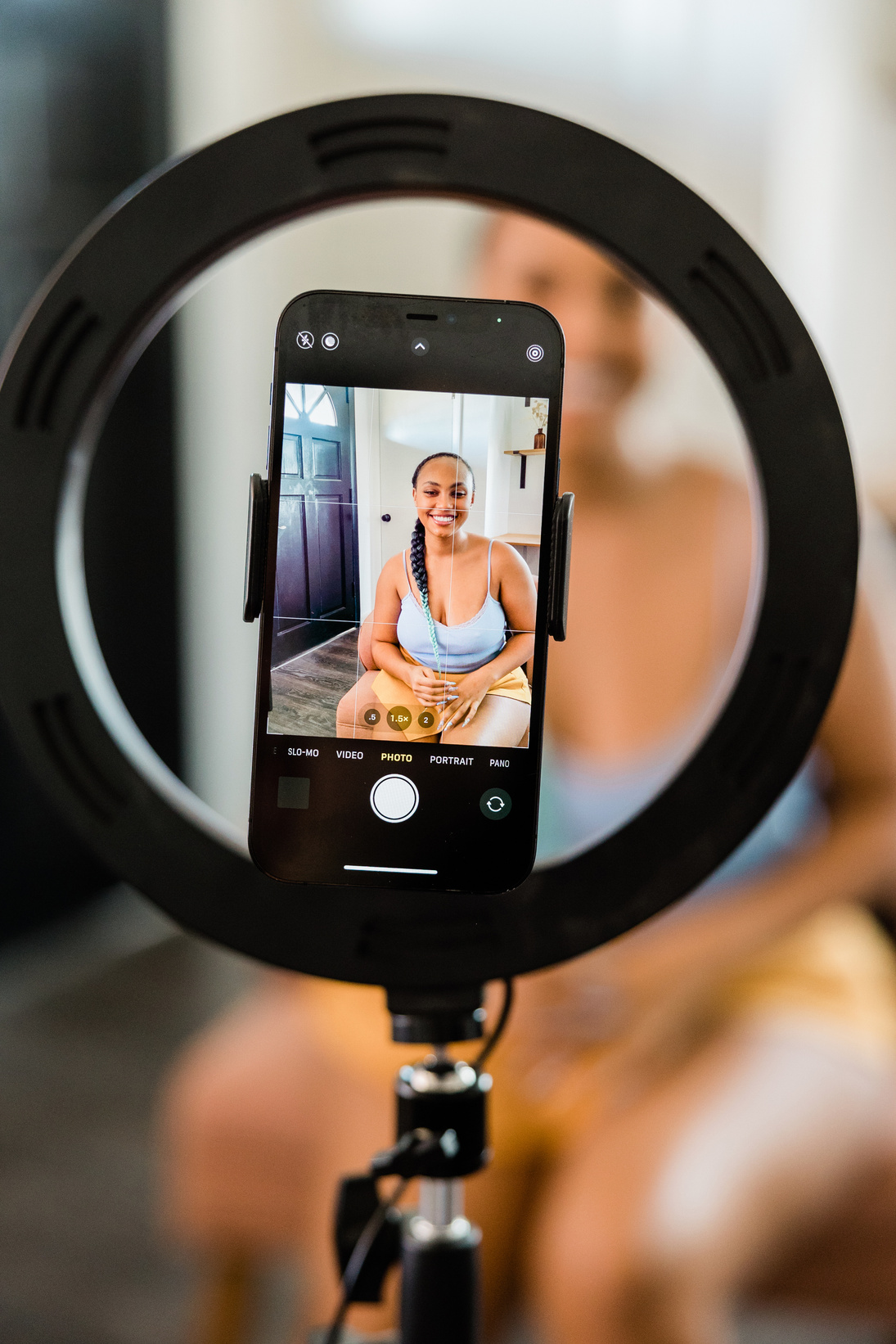 Woman Recording Herself on Smartphone with Ring Light